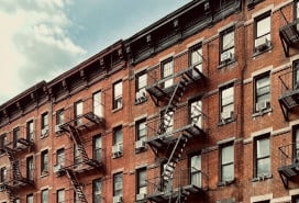 brick apartment building adorned with iconic fire escapes.